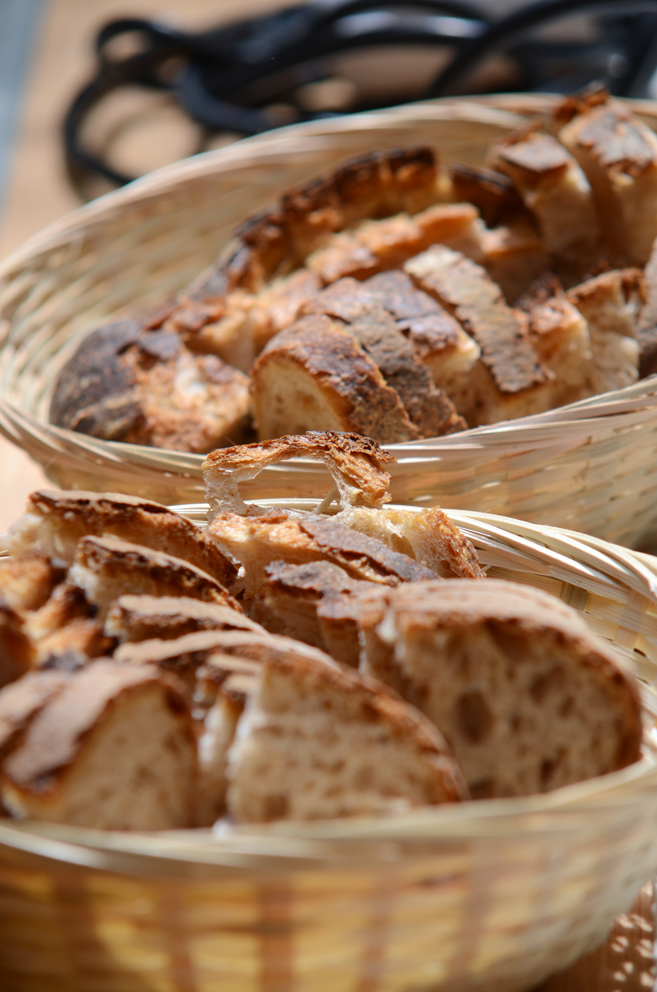 Two baskets filled with cut artisinal bread